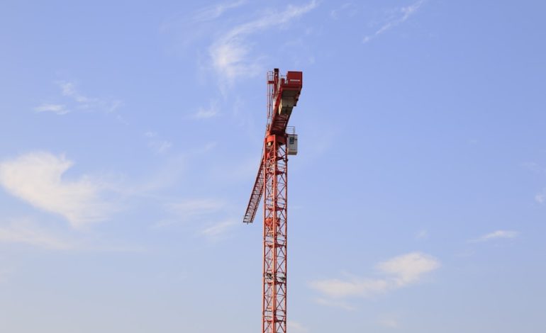 Workers inspecting crane components for safety compliance