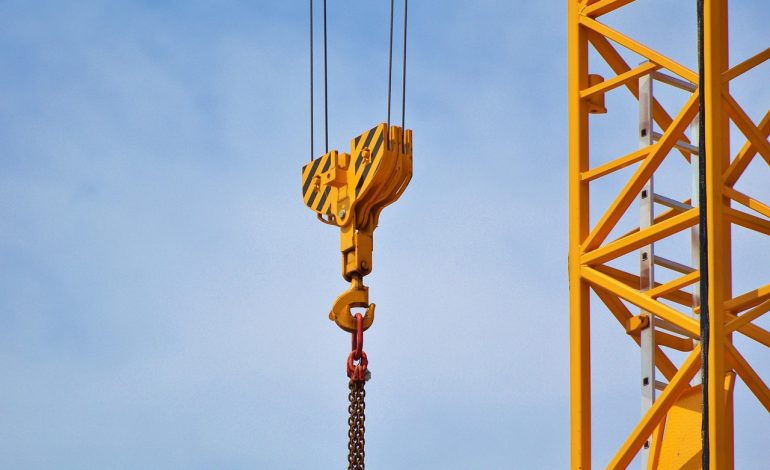 Engineer performing a crane safety inspection with checklist to ensure OSHA compliance