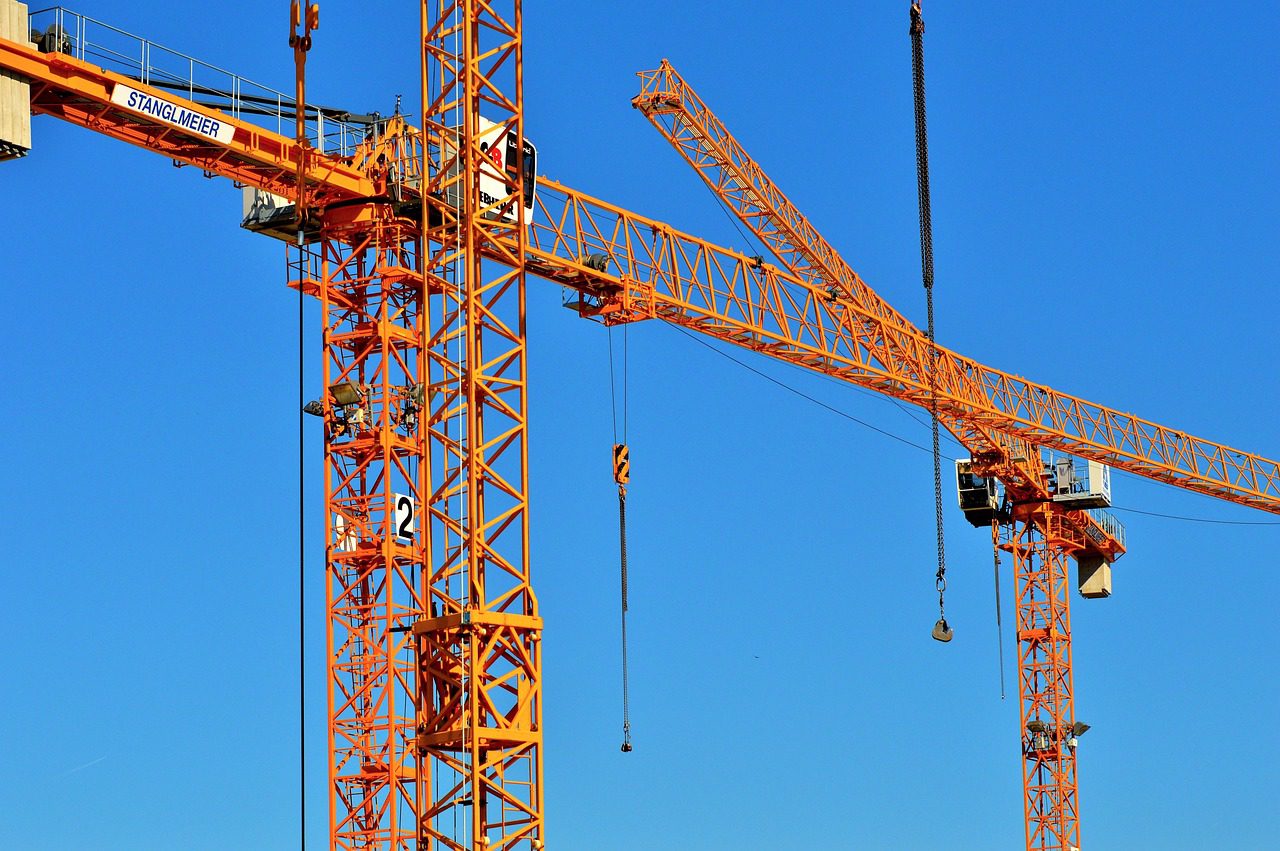 Certified crane inspector examining a mobile crane on a construction site