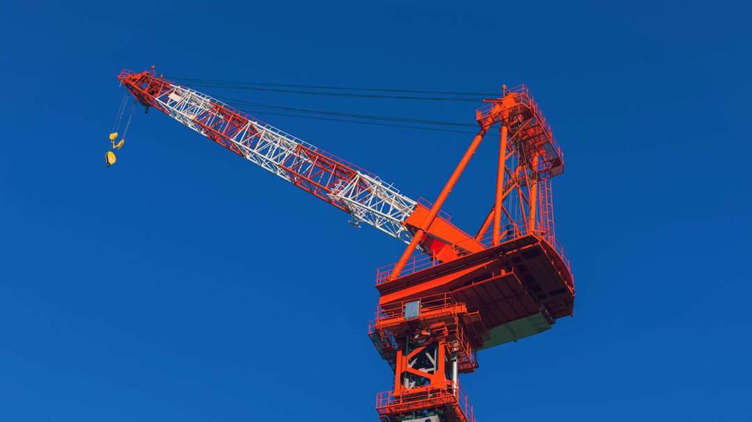 Hydraulic crane maintenance technician inspecting fluid levels